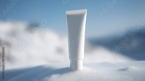 White cosmetic tube mock up placed on soft snow surface with blurred winter landscape in background, showcasing product design and branding possibilities for skincare or beauty industry