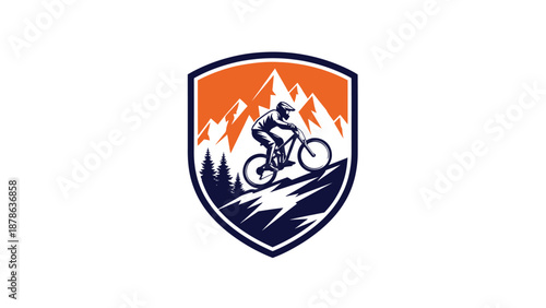 Mountain biker riding downhill on a trail with a scenic mountain background in a crest logo