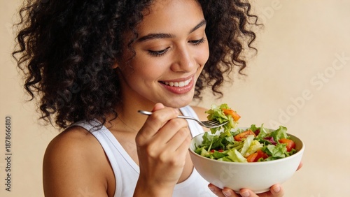 Woman eating salad with fork