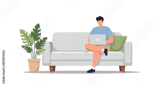 A man sitting comfortably on a grey sofa, working on his laptop, with a large potted plant beside him, depicting remote work or leisure.