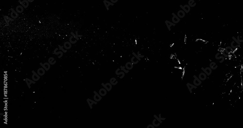 Super slow motion bullet impact shattering glass filmed at 1000fps. Side view of gunshot breaking window with flying shards and dust isolated on black background. Perfect VFX overlay element.