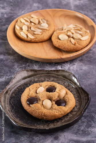 soft cookies with almond macadamia and chocolate on a table and plate