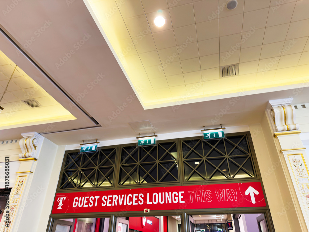 Fototapeta premium Indoor lobby with guest services sign and exit indicators in Manchester UK