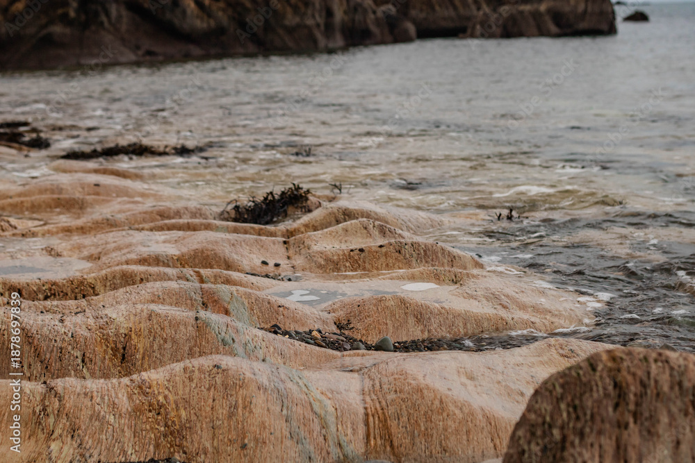 Ταπετσαρία A rocky beach with eroded limestone, waves lapping against the rocks, Ireland