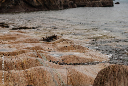 Tableau sur toile A rocky beach with eroded limestone, waves lapping against the rocks, Ireland