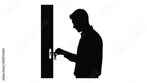 Silhouette of a man carefully inserting a key into a door lock mechanism intending to open or secure an entrance with a set of attached metal keys
