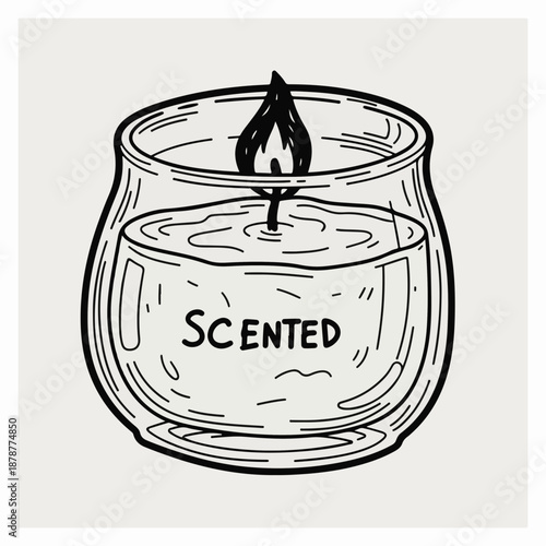 Scented candle burning in a glass jar on a neutral background