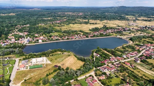 Scenic view of Tismana village in Gorj County Romania under a bright blue sky with fluffy clouds. A stunning landscape captures the beauty of Tismana village in Gorj County. Tismana, Romania.
