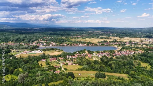 Scenic view of Tismana village in Gorj County Romania under a bright blue sky with fluffy clouds. A stunning landscape captures the beauty of Tismana village in Gorj County. Tismana, Romania.