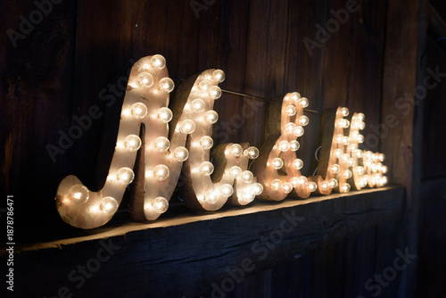 Angled View of Mr. and Mrs. Lighted Sign on Wooden Barn Wall