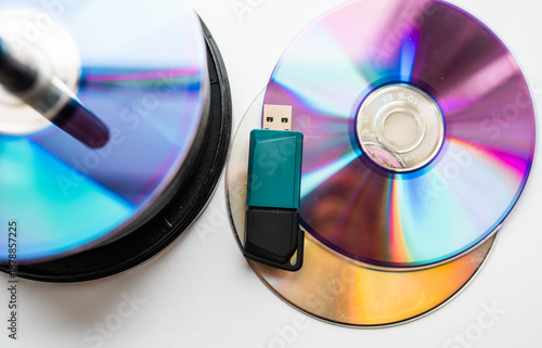 Fotografie Bunch of CD and DVD discs with USB flash drive placed on them.