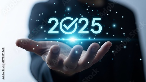 Person holding glowing 2025 with checkmark in hand