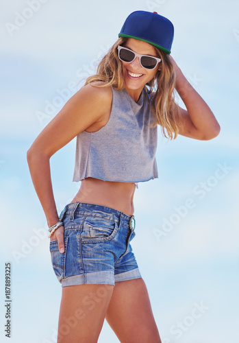 Blue sky, fashion and woman with smile, summer and happiness with stylish clothes, laughing or sunglasses. Person, outdoor or girl with funky eyewear, sunshine or casual outfit with vacation or funny