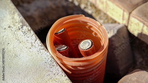 Quadro em tela Electric cables inside orange protective conduit in construction site