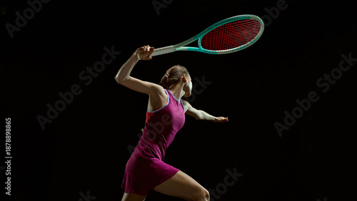 Tablou pe pânză Female tennis player reaching for ball in dramatic motion