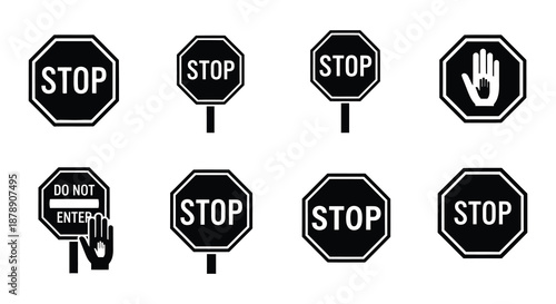 Collection of black and white stop signs and hand halt symbols displayed