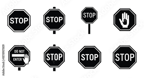 Collection of black and white stop signs and hand halt symbols displayed