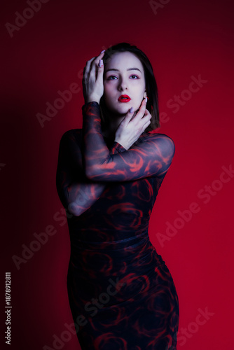 Fotografi Studio portrait of woman in red dress with red lighting