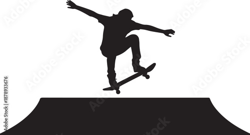 Silhouette of a skateboarder performing a trick on a ramp