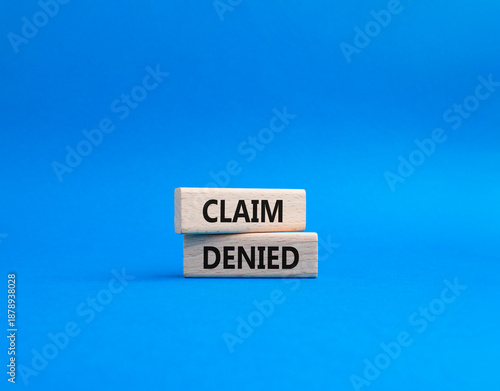 Claim denied symbol. Wooden blocks with words Claim denied. Beautiful blue background. Business and Claim denied concept. Copy space.