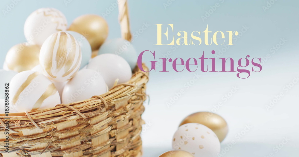 Fototapeta premium Image of easter greetings text over white and gold easter eggs in basket on blue background