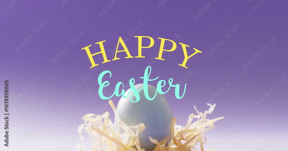 Fototapeta premium Image of happy easter text over blue easter egg in hey on purple background