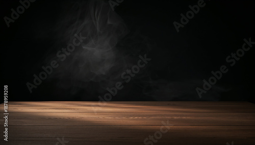 Empty wooden table surface with wisps of smoke against a dark background