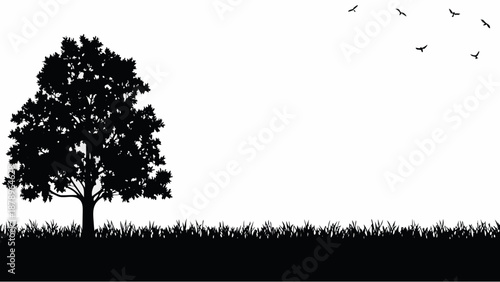 Serene landscape with tree and birds in flight at sunset