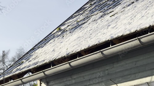 rain gutter with thawing snow and ice