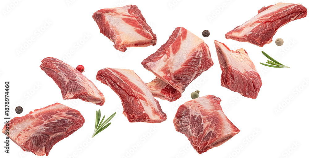 Fototapeta premium Falling raw beef rib pieces isolated on white background, full depth of field