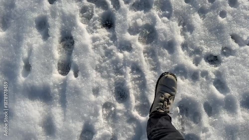 winter walk with footprints in snow on rural road