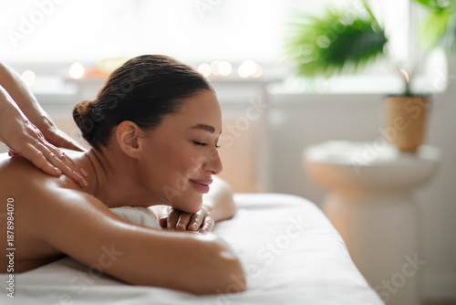 Free Download Self Care. Beautiful lady receiving back and shoulder massage from professional therapist in spa salon, enjoying wellness treatment, side view, copy space - GFXLoad