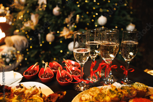 Empty Champagne Flutes with Red Ribbons on Festive Holiday Table