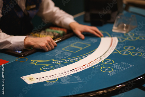 Cuadro en lienzo Casino Dealer Dealing Cards at Poker Table with Chips