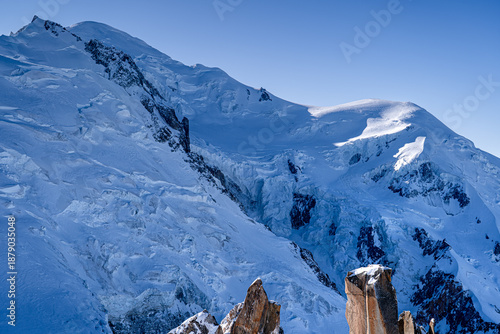 Snow-capped Mont Blanc massif with glacier in winter. The highest peak in Europe, Alps, Chamonix-Mont-Blanc, France. View from the peak Aiguille du Midi.
