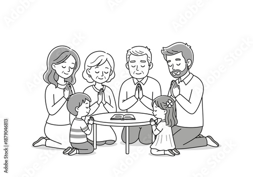 Multi-Generational Family Praying Together Around a Table with a Book