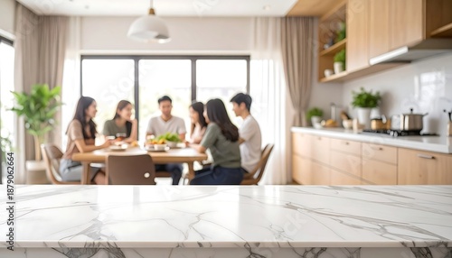 Empty Marble Countertop in a Modern Kitchen with a Group of Friends Dining in the Background