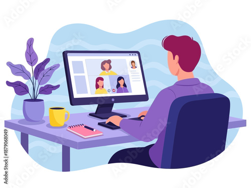 Man sitting at desk working on computer with video conference on screen in modern office with plant and coffee