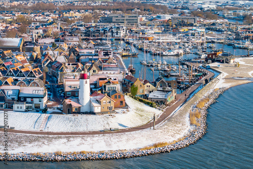 Aerial view of Urk harbor in winter with lighthouse and fishing boats