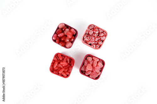 Schilderij op canvas Valentine themed red and pink candy in pink and red silicon containers on white
