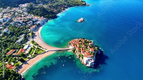 Aerial drone view of the beach and Sveti Stefan Island. Beautiful architecture and the blue Adriatic Sea. Sveti Stefan, Montenegro.