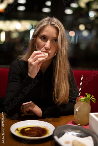 young woman eating a meal in the restaurant