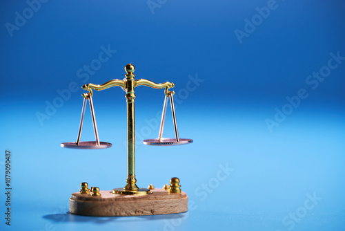 small libra scale on blue background