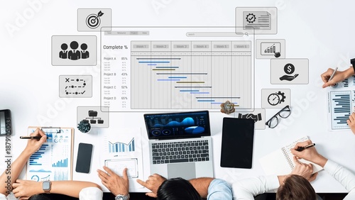 Fotografie A dynamic workspace scene featuring a laptop, diverse professionals collaborating on project management and data visualization to enhance business strategies and growth