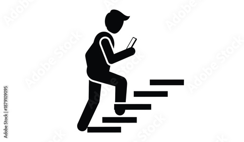 Silhouette of a person walking up stairs while using a mobile phone