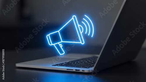Glowing blue megaphone icon projected from laptop screen for announcement or communication