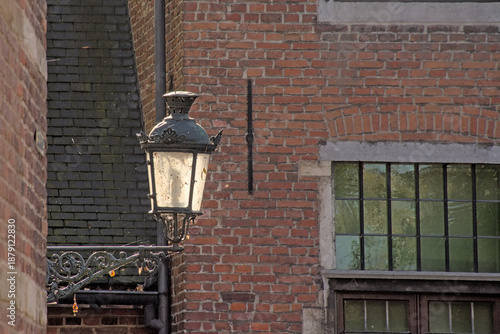 Wallpaper Mural Street lantern backlit by the sun in front of a brick wall of a historic house in Louvain Beguinage, Flanders, Belgium  Torontodigital.ca