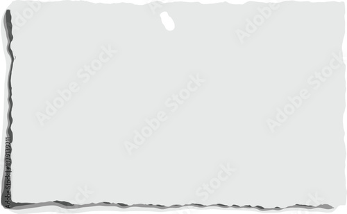 Torn paper edge with rough texture and irregular border on a plain surface viewed from directly above