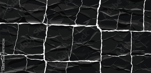 Cracked black surface viewed from directly above showing texture and pattern of broken material