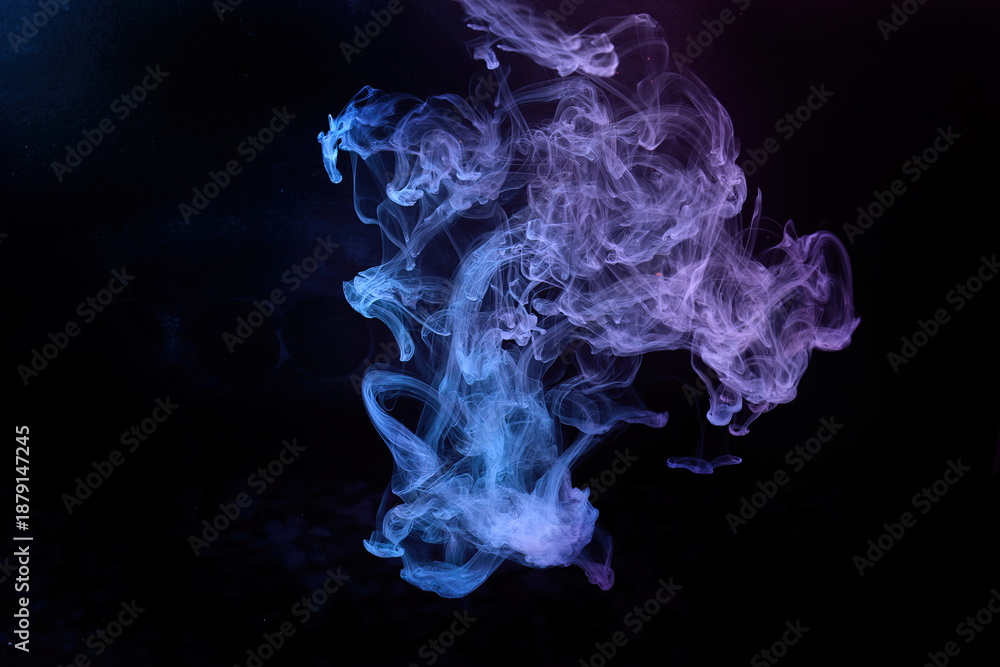 Fototapeta premium Colorful ink swirling in water creating abstract patterns